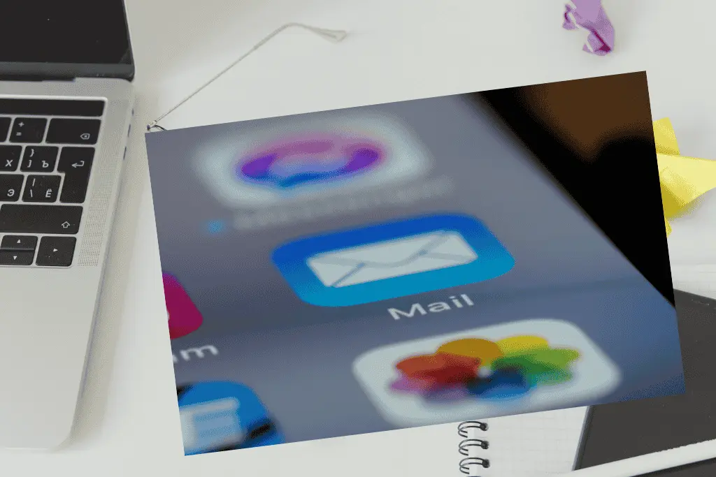 Email app icon on a mobile screen next to a laptop, illustrating how Brevo helps you grow your email list fast